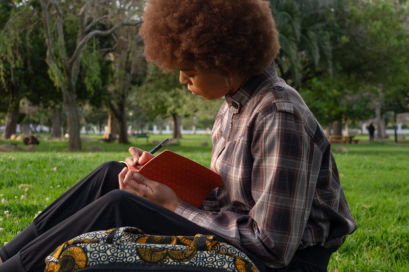 photo of a woman writing in a notebook