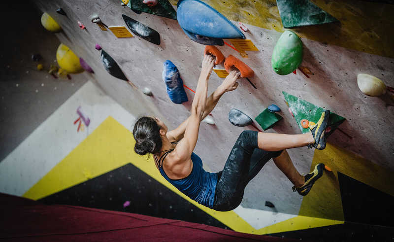 photo of a woman on a bouldering wall