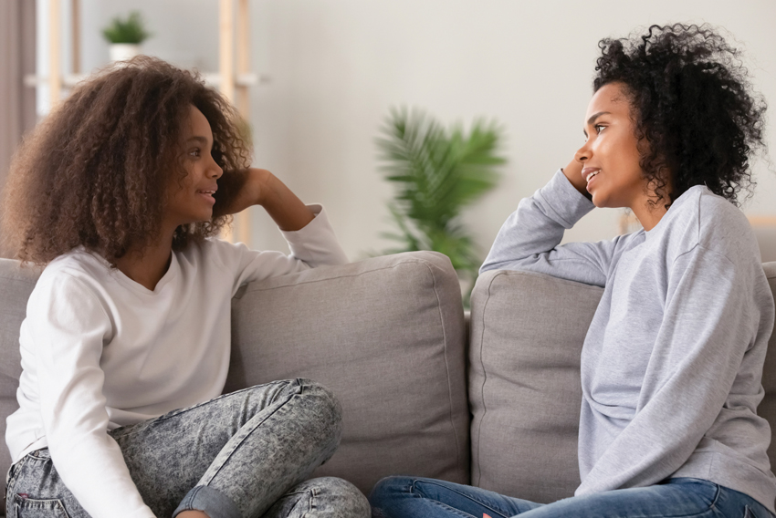 photo of two women talking to each other