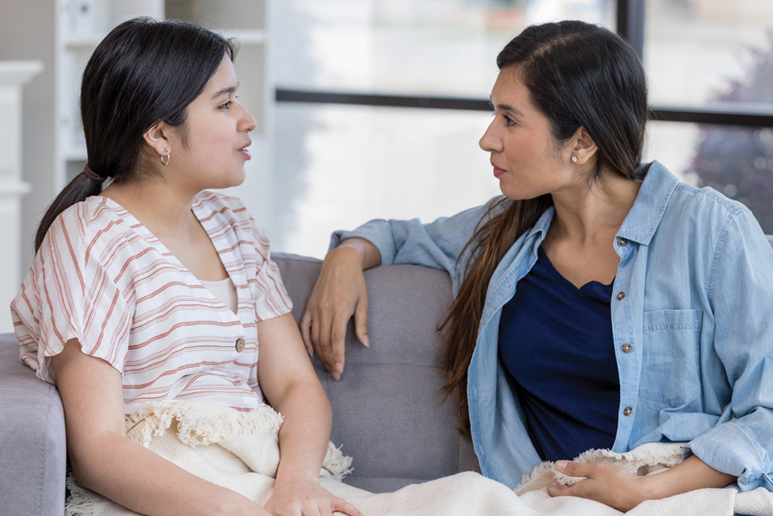 photo of two women talking to each other