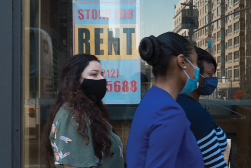 stock photo of people in front of a closed storefront