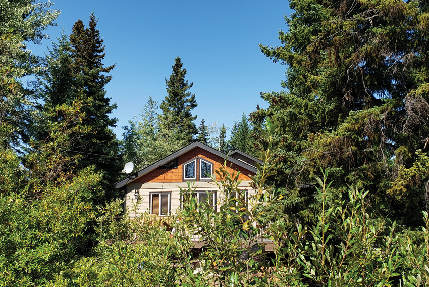 Photo of house surrounded by trees