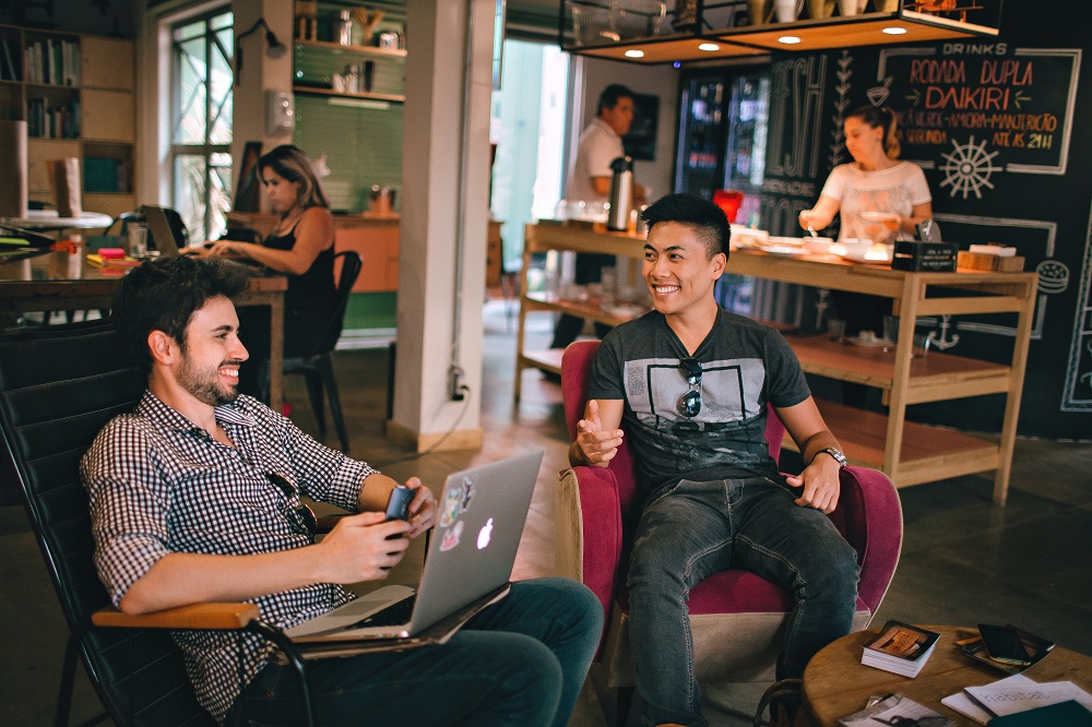 photo of two men talking at a coffee shop