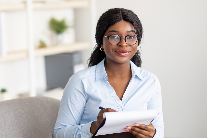 Stock photo of woman writing on a notepad