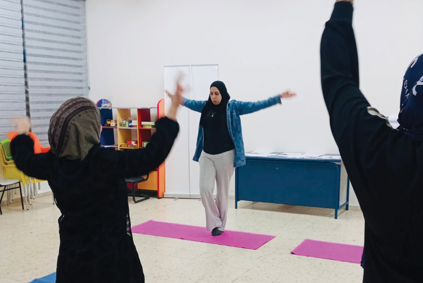 Women who identify as refugees and Arabic speaking practicing yoga