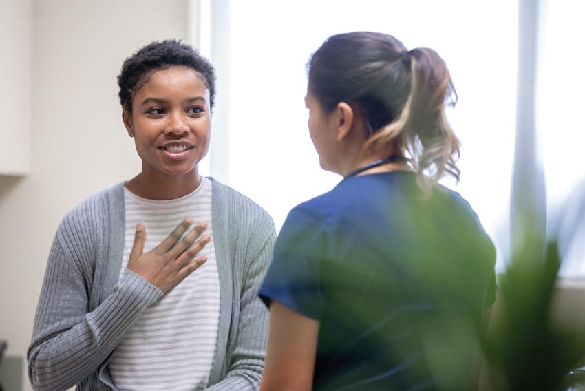 Stock photo of a woman talking to a medical professional