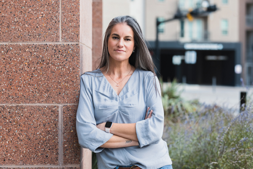 Stock image of a woman leaning against wall