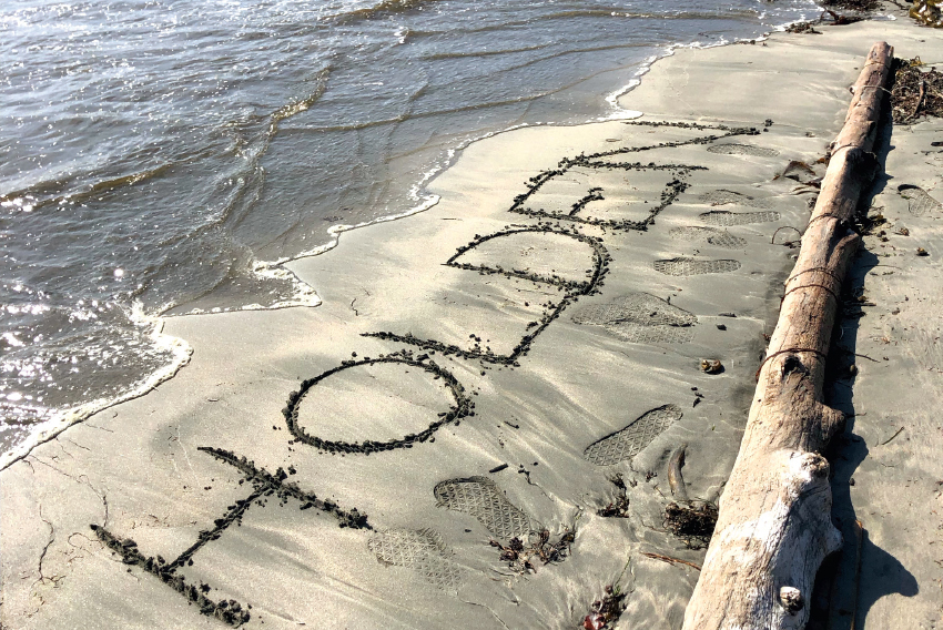 The name Holden written into sand on a beach