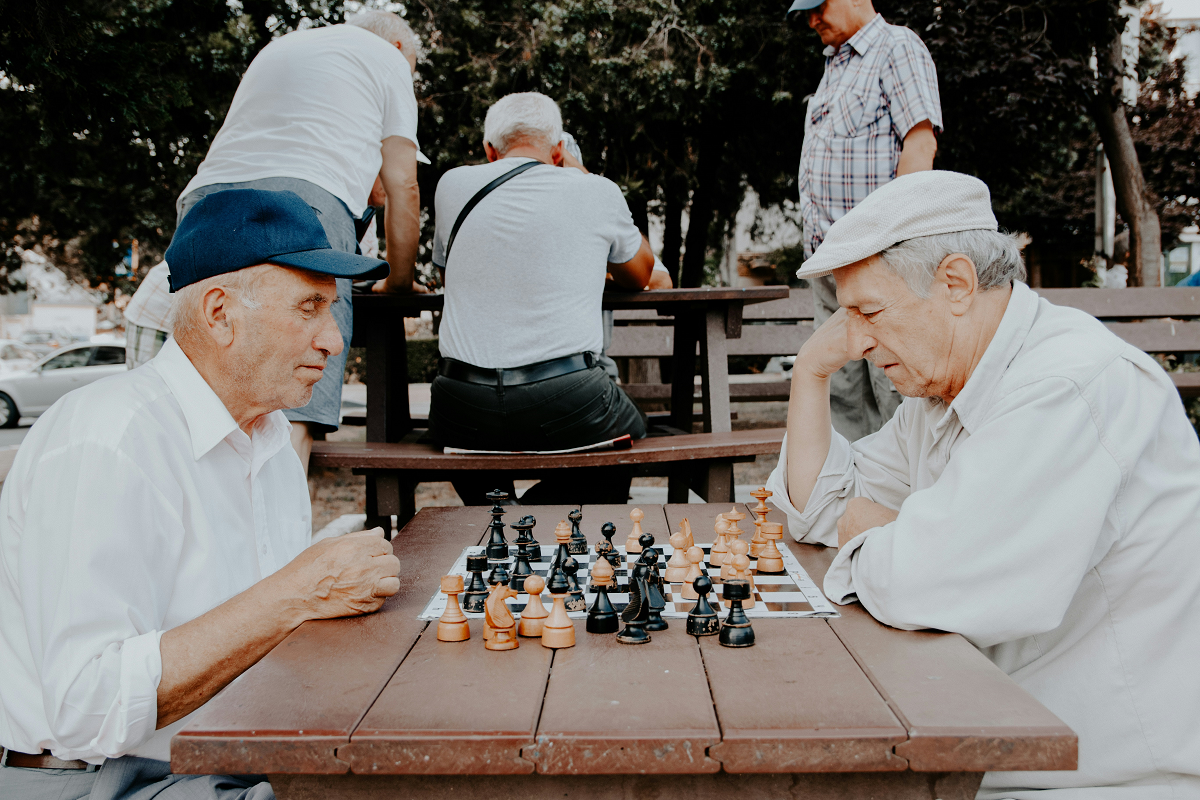 stock photo of two older men playing chess in a park
