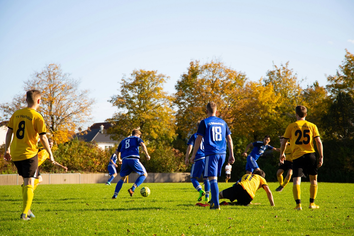 photo of young men playing soccer
