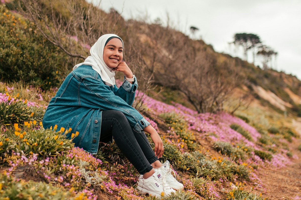photo of a young person sitting in a park