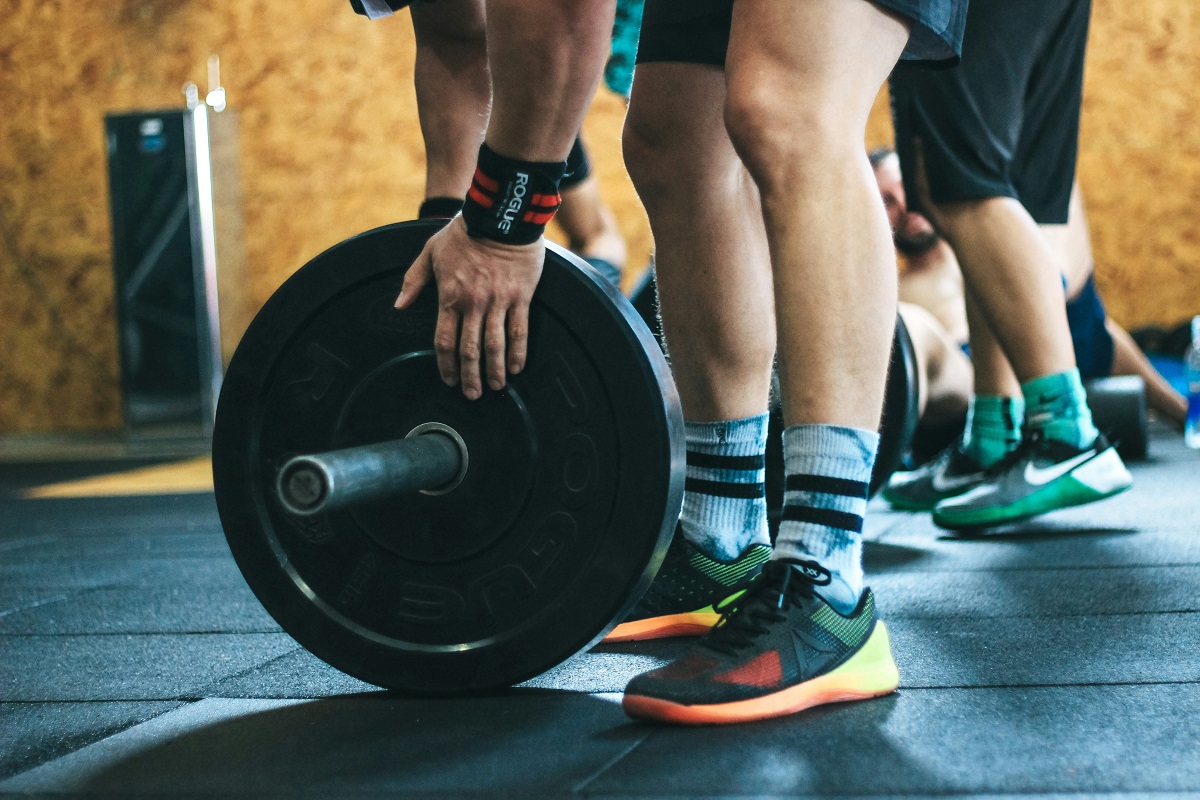 image of a person adding a plate to a barbell