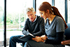 Stock image of nurse helping to fill out a form