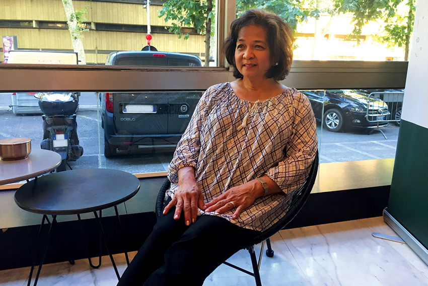 Janet Peralta Laguio seated next to a window