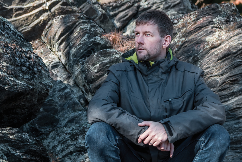 Man sitting down in forest Stock photo