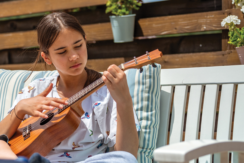 Girl playing ukalele Stock photo