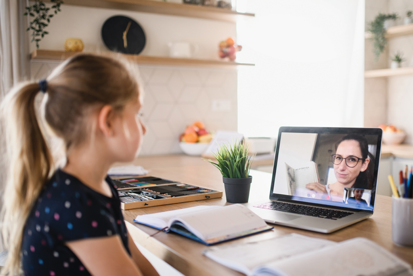 Stock photo of student and teacher in the midst of online learning